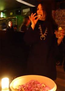 Pixie 66 tastes one of Nancy "Jeannie" Gardener's chocolate crinkles at the WHAM-O WATUSI.